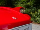 a red sports car parked on the side of the road