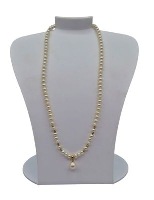 a close up of a necklace with pearls on a mannequin