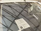 a car that has a sticker on it ' s windshield