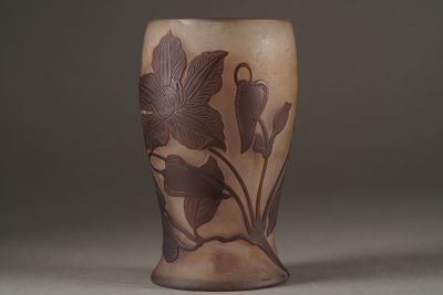 a vase with a design of flowers and leaves on it