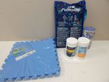 a blue mat, a bag of food, and some other items on a table
