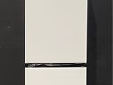 an image of a white refrigerator against a black wall