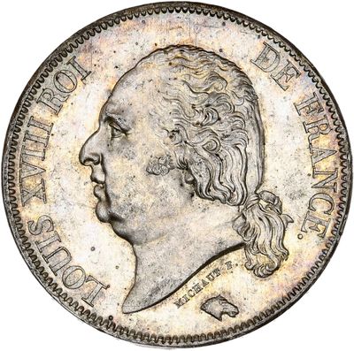 une pièce d'argent sur laquelle figure le portrait d'un homme de profil