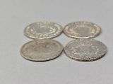 a close up of four coins sitting on top of a table