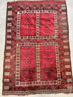 an old rug with a red and brown design on it
