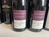 several bottles of wine are lined up on a counter