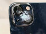 a close up of a cell phone with a broken screen