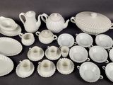 many white dishes and cups and saucers on the table