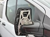 a side view mirror of a white van with a chain attached to it