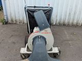 an image of a machine that is sitting in front of a building