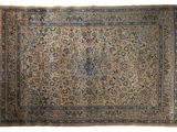 un tapis persan ancien aux couleurs bleues et beiges