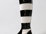 a close up of a pair of black and white boots on a white background