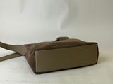 the small bag is brown and has a strap on it