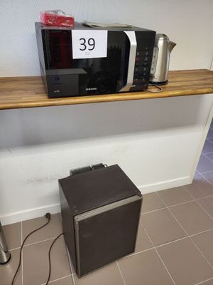 un micro-ondes et un grille-pain posés sur une étagère