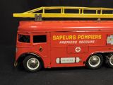 a toy fire truck with a ladder on top of it