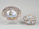 two plates and a bowl with a picture of a ship on them