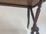 an old wooden table with two legs and a wooden top
