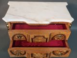 an image of a marble topped chest of drawers on a table