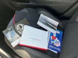 a car seat with books and magazines in it