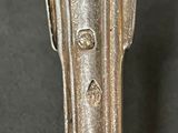 a close up of a silver spoon on a table