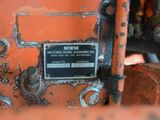 a close up of a rusted machine with a sign on it
