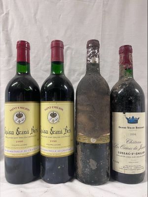 four bottles of wine are lined up on a table