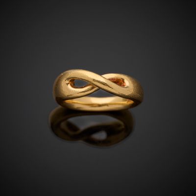 an image of a gold ring on a black surface
