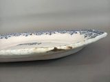 a blue and white bowl on a gray table