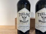 deux bouteilles de whisky posées l'une à côté de l'autre sur une étagère