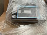 a laptop sitting on a table covered in plastic wrap