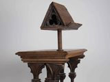 an old wooden birdhouse with a birdhouse on top of it