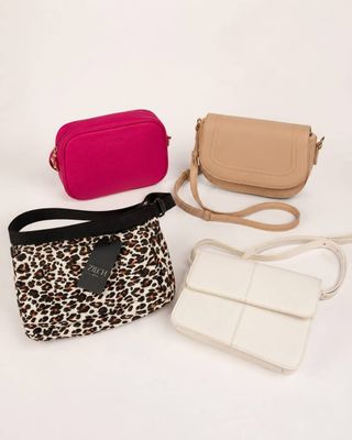 three different purses and a purse strap on a white background