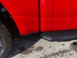 a red truck that is parked on the side of the road