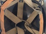 an old military helmet is sitting on top of a table