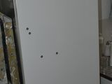 a refrigerator in the kitchen with a lot of clutter on it