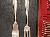 two forks and two spoons in a red case