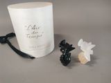 a candle and a small figurine sitting next to it