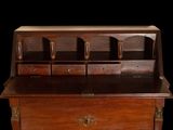 a wooden desk with drawers and drawers on top of it