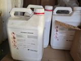 two containers of liquid sitting on a cardboard box