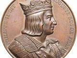 an image of a bronze medal with a man wearing a crown