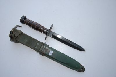 a knife and a knife holder on a white surface