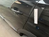 a black car with a sticker on the side of it
