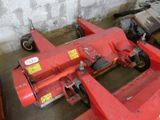 a red machine that is sitting in a garage