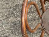 a wooden chair with a brown seat and a brown chair with a brown seat