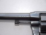 a close up of a revolver on a white surface