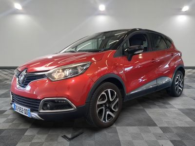 a red car parked on a checkered floor in a garage