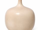 a white vase that is sitting on a white surface