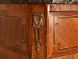 a wooden cabinet with a marble top in a room