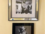 two pictures hanging on the wall above a toilet