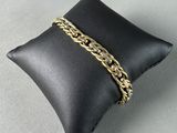 a black pillow with a gold chain on it